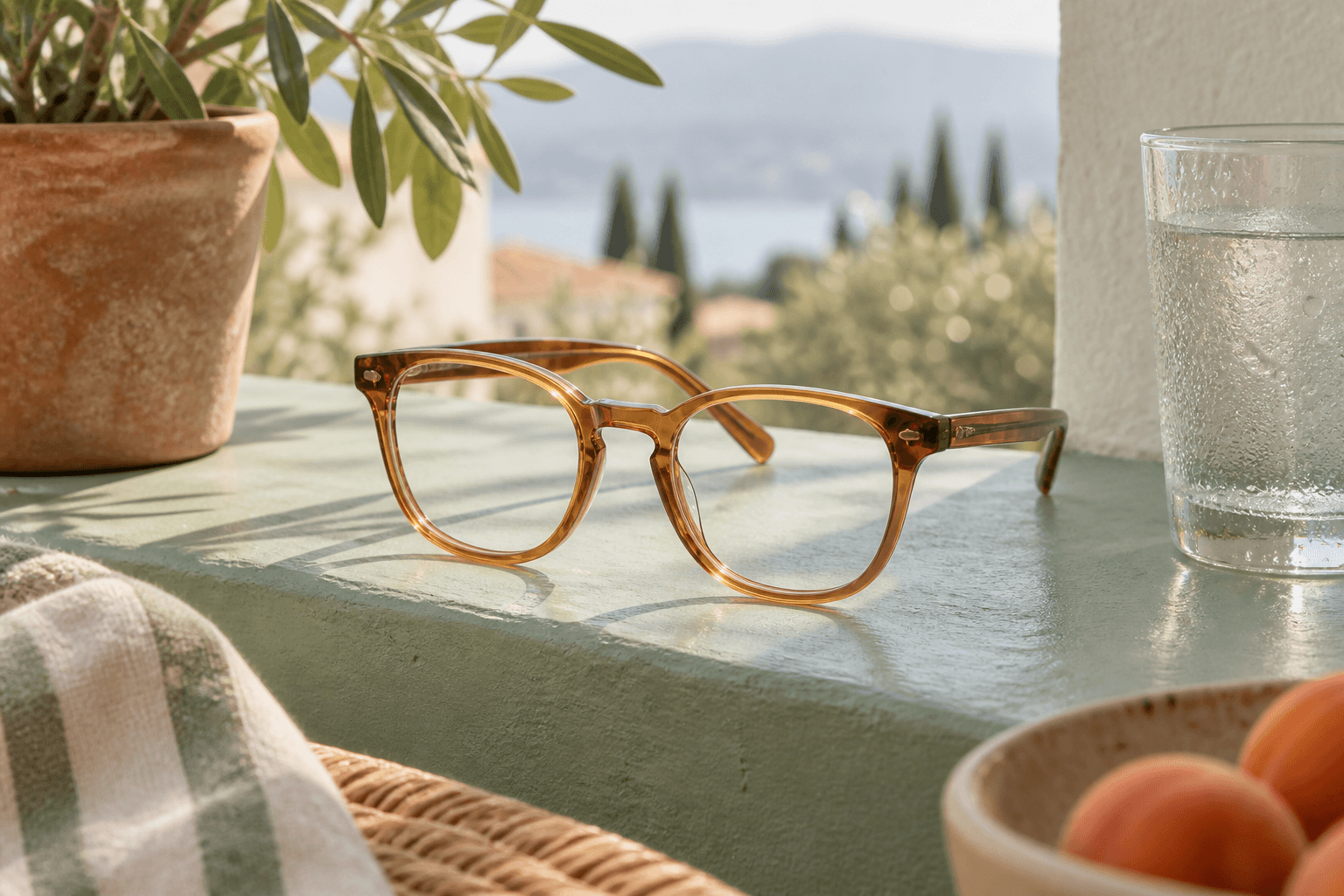 Translucent amber glasses on a mint ledge beside a water glass with condensation.